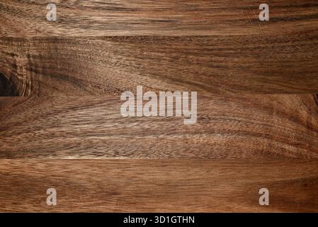 Close-up of wooden surface with visible grain and warm brown color. Natural organic texture for design, product display, rustic surface mockup. Stock Photo