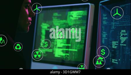 Male analyst wearing hoodie analyzing green code in dim office, with floating eco icons, copy space Stock Photo