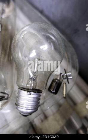Detail of an old filament light bulb that has blown and is in the trash. Stock Photo