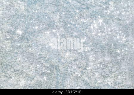 The background of the fabric is decorated with a scattering of silver sequins creating an abstract shimmer. Festive energy and luxury. Stock Photo