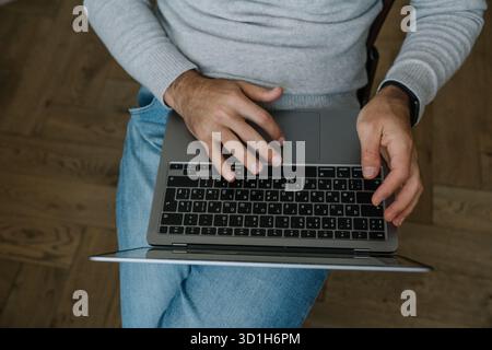 Top view of male hands typing on laptop keyboard, workspace concept Stock Photo
