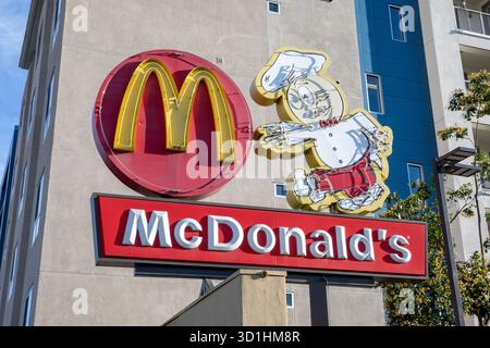A McDonald's sign featuring the golden arches logo and an arrow