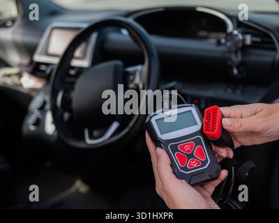 Woman using OBD2 diagnostic scanner.  Stock Photo