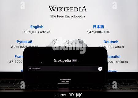 Grokipedia v0.1 on smartphone placed before Wikipedia homepage. Concept for  encyclopedias competition. Stafford, United Kingdom, October 28, 2025 Stock Photo