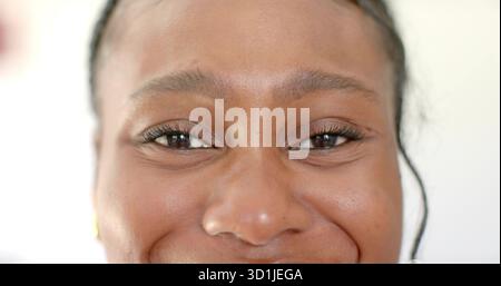 Showing close-up adult woman featuring smooth skin and braids in studio with white backdrop Stock Photo