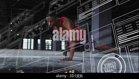 Performing push-ups man wearing red tank top and shorts in warehouse, with AR charts, copy space Stock Photo