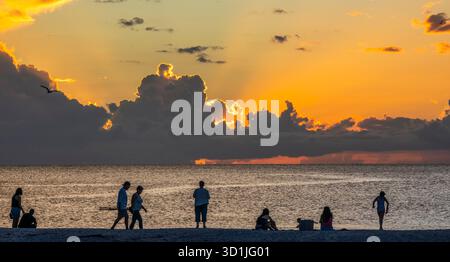 People on the beach watching the sunset over the Gulf of America, formerly the Gulf of Mexico iFrom Nokomis Beach in southwest Florida USA Stock Photo