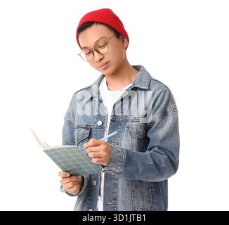 Young Asian man writing something in notebook on white background Stock Photo