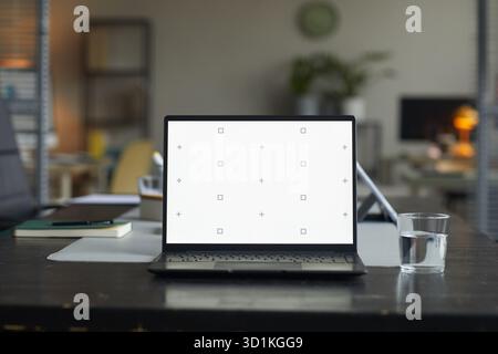 Modern Laptop Displaying Blank Screen on Office Desk during Workday Stock Photo