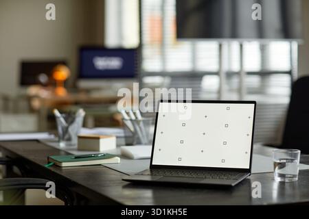 Modern Laptop Displaying Calibration Screen on Office Desk during Daytime Stock Photo