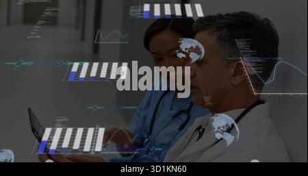 Doctors with stethoscopes in coat and scrubs holding tablet, viewing overlays in hospital corridor Stock Photo