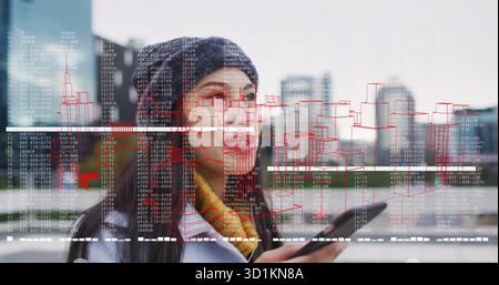 Using smartphone, woman wearing beanie scanning augmented reality overlay on rooftop terrace Stock Photo