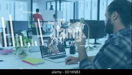 Holding mug bearded man in checkered shirt viewing call on laptop at open-plan office, copy space Stock Photo