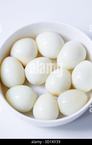 Boiled quail eggs on a white plate isolated on white background Stock Photo