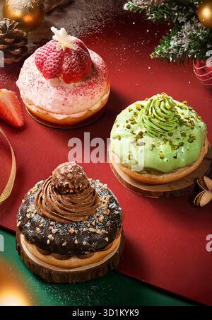 Festive Christmas Donuts with Strawberry Pistachio and Chocolate Toppings on Red Holiday Background Stock Image Stock Photo