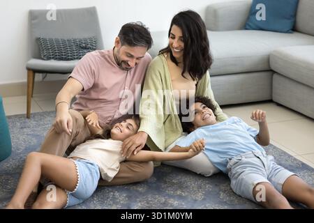 Happy family playing on floor in living room Stock Photo