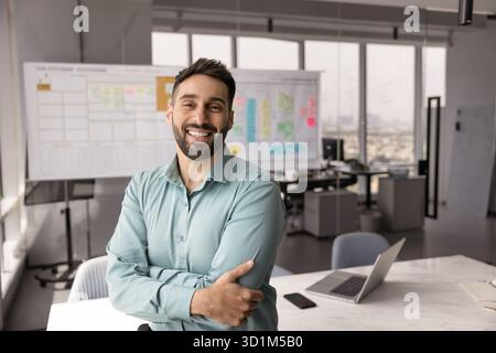 Portrait smiling young businessman standing at modern Agile office space Stock Photo