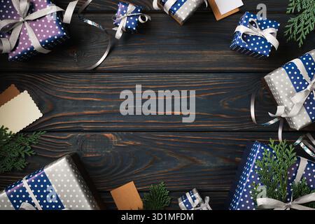 Frame of blue and silver gift boxes on blue wooden background. Copy space Stock Photo