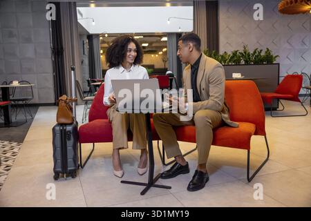 New project. Business partners discussing new project and looking involved Stock Photo