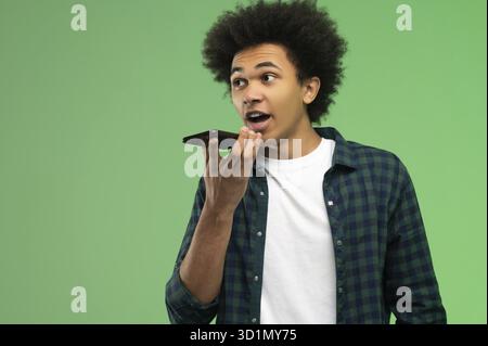 Voice message. Young african american recording a voice message Stock Photo