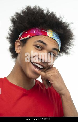 Confidence. Young guy in red shirt looking contented and determined Stock Photo