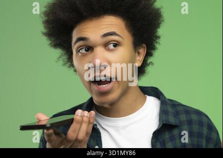 Voice message. Young african american recording a voice message Stock Photo