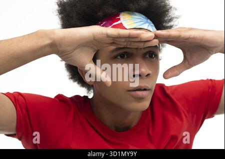 Anticipation. Young guy in red tshirt looking anticiapted Stock Photo