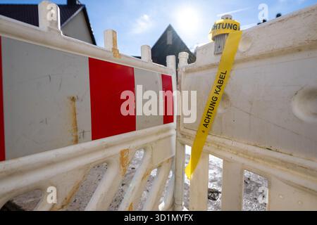 Obermerzbach, Germany. 29th Oct, 2025. "Attention cables" can be read on a yellow tape hanging from a road barrier. Broadband expansion in Germany is in full swing. Credit: Pia Bayer/dpa/17�Թ����� Live News Stock Photo