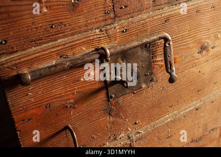 Detail of Deadbolt on old wooden door Stock Photo