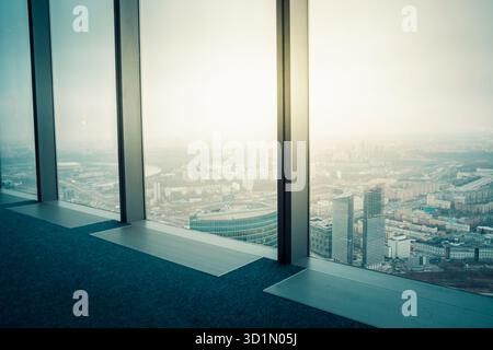 Empty interior with panoramic city view. Aerial view of modern city from skyscraper huge window. Skyline and buildings from glass window. Stock Photo