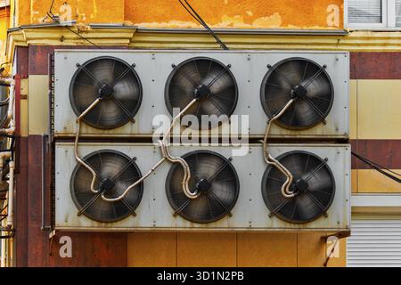 Industrial Air Conditioner System Mounted On Old Warehouse Wall With Many Connection Pipes All Over Stock Photo