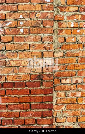Red brick wall with quorter made of bright red blocks Stock Photo