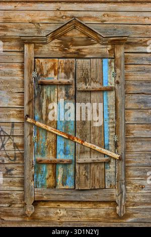 Weathered wooden window in slums Stock Photo