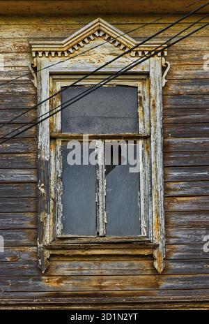 Weathered wooden window in slums with broken glass Stock Photo