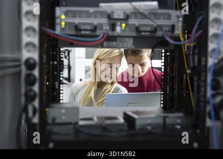 Two IT Engineers in Data Center, Server Room Stock Photo