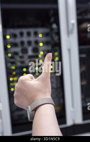 Close-up Of Engineers hand checking Server In Data Center Stock Photo