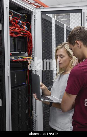 Two IT Engineers in Data Center, Server Room Stock Photo