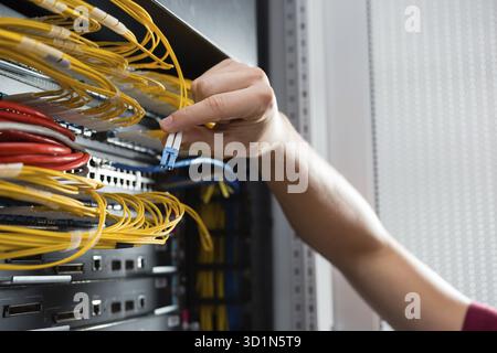 Man fix server network in data center room Stock Photo