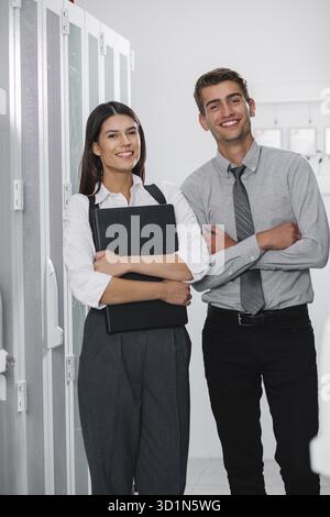 Team of technicians working together on servers at the data centre Stock Photo