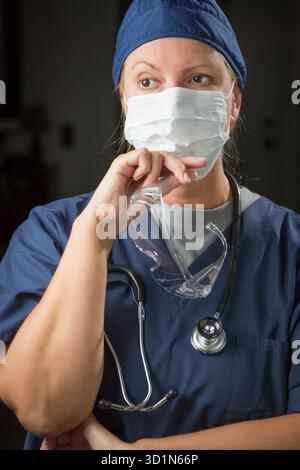 Female Doctor or Nurse Wearing Protective Face Mask Stock Photo