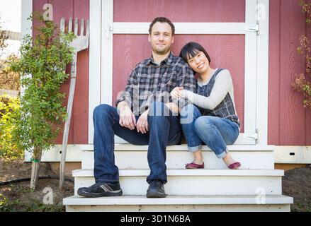 Mixed Race Couple Relaxing on the Steps Stock Photo