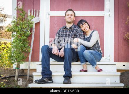Mixed Race Couple Relaxing on the Steps Stock Photo