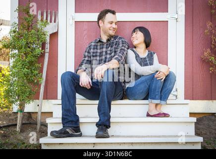 Mixed Race Couple Relaxing on the Steps Stock Photo