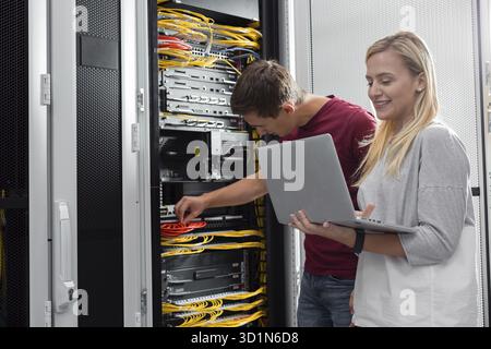 Team of busienss people working in server room Stock Photo