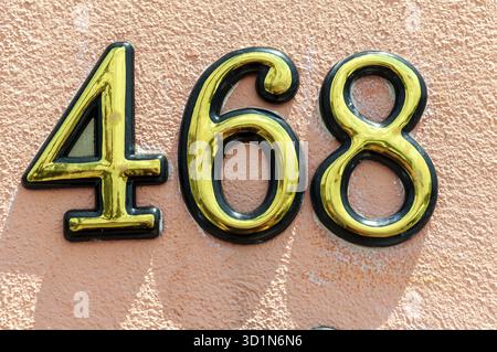 House number plate 468 on a wall. Street number. Address number, Limanu, Romania Stock Photo