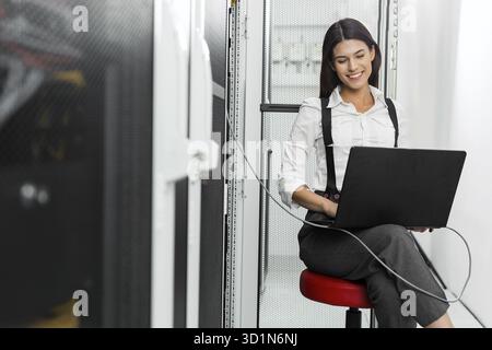 Technician examining server in server room Stock Photo