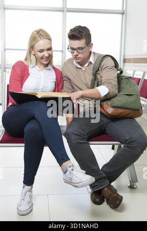 Group of young students collaborating on project in library Stock Photo