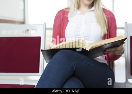 Student preparing exam and learning lessons in school library, making research Stock Photo