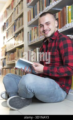 Student preparing exam and learning lessons in school library, making research Stock Photo
