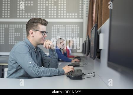 Office with casual dressed workers working on computers Stock Photo